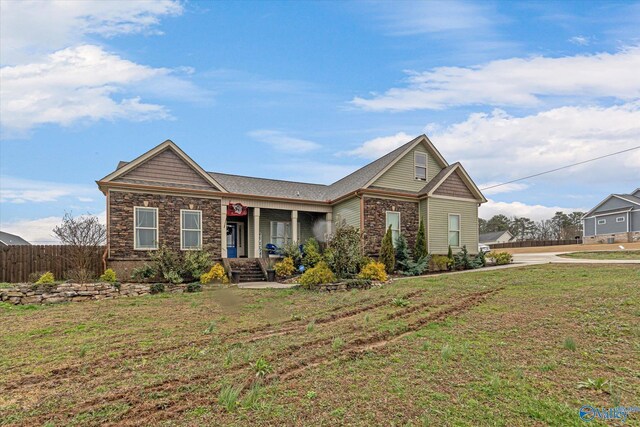 view of front facade with covered porch and a front lawn