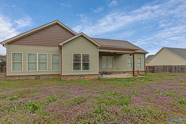 back of house featuring crawl space, a patio, a lawn, and fence