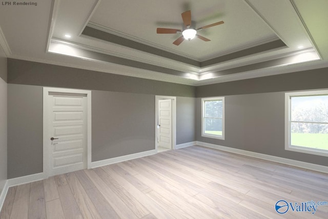 unfurnished room featuring a raised ceiling, crown molding, a healthy amount of sunlight, and light wood-type flooring