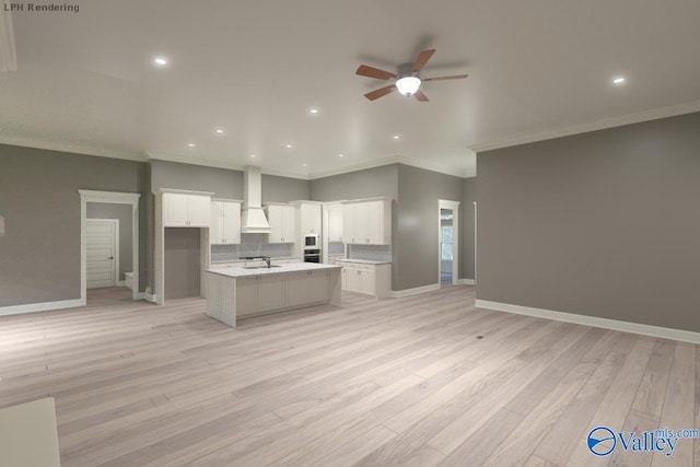 kitchen featuring white cabinets, backsplash, a kitchen island with sink, and sink