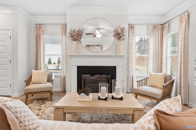 living room featuring hardwood / wood-style flooring, ornamental molding, and a healthy amount of sunlight