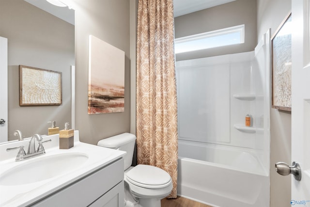 full bathroom with vanity, shower / tub combo, and toilet