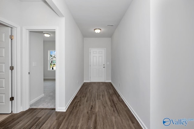 corridor featuring dark hardwood / wood-style floors