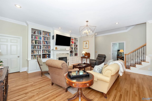 living room with ornamental molding, a premium fireplace, and light wood-type flooring