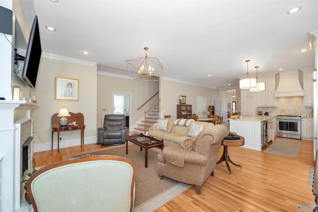 living room featuring wine cooler, crown molding, a chandelier, and light hardwood / wood-style flooring