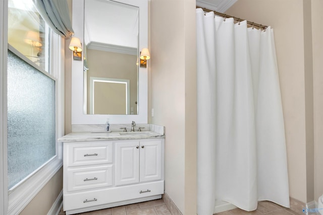 bathroom with tile patterned flooring, vanity, and ornamental molding