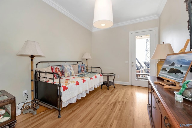 bedroom featuring ornamental molding, access to exterior, and light hardwood / wood-style flooring