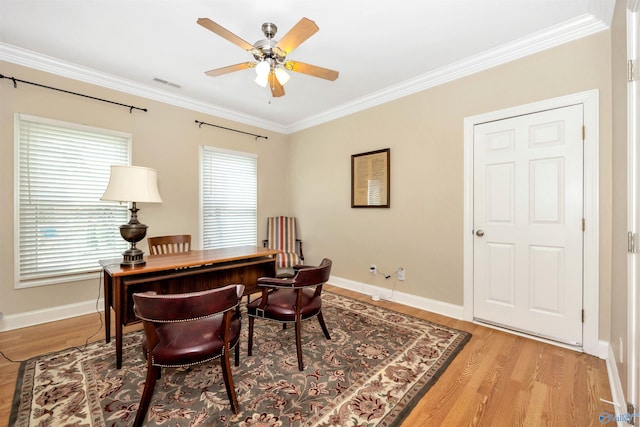 office space with crown molding, ceiling fan, and light hardwood / wood-style flooring