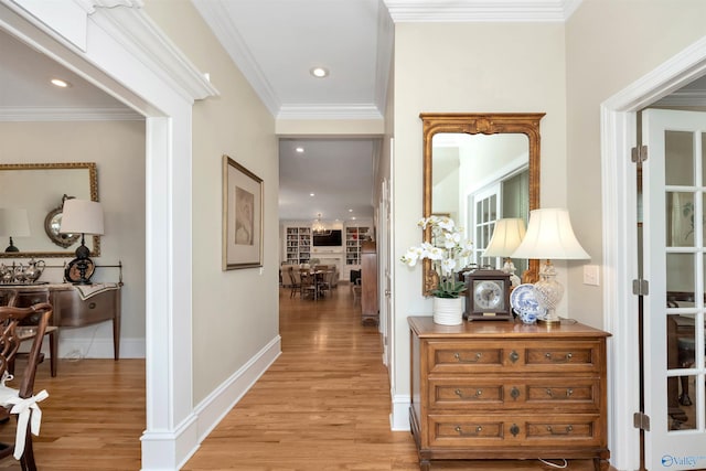 hallway featuring ornamental molding and light wood-type flooring