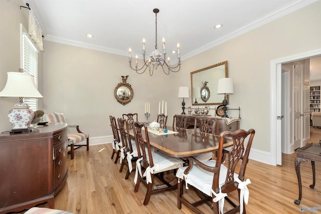 dining room with crown molding, light hardwood / wood-style floors, and a notable chandelier