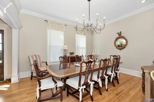 dining area with crown molding, light hardwood / wood-style flooring, and a chandelier