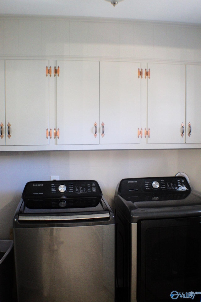 washroom with cabinets and separate washer and dryer