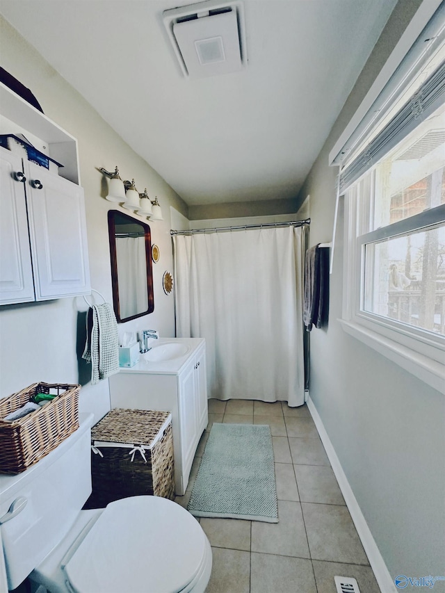 bathroom featuring toilet, tile patterned flooring, vanity, and curtained shower