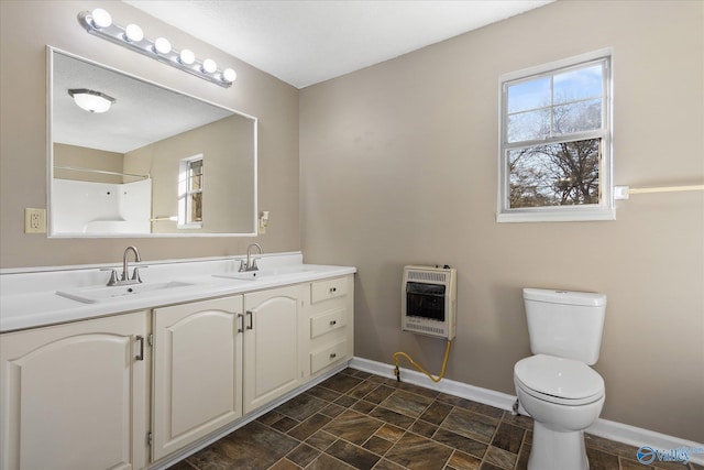 bathroom featuring vanity, toilet, a shower, and heating unit