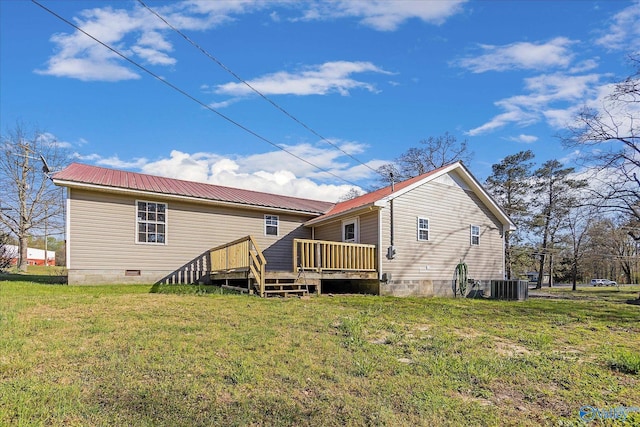 back of property with central air condition unit, a yard, and a wooden deck