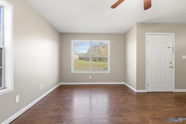 unfurnished room with ceiling fan, dark hardwood / wood-style flooring, and a textured ceiling