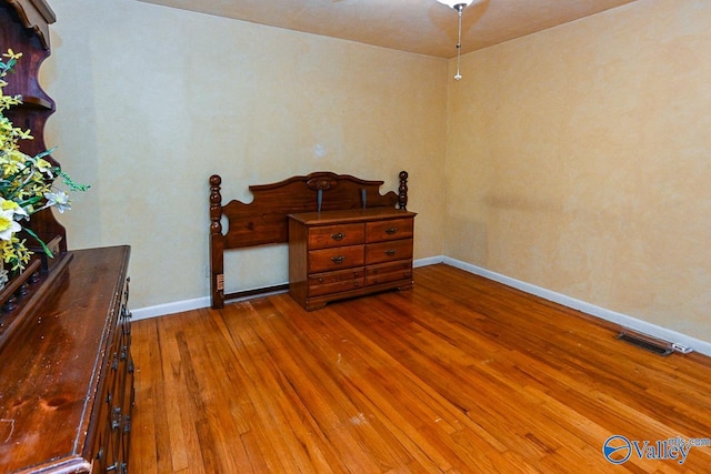 bedroom with hardwood / wood-style flooring