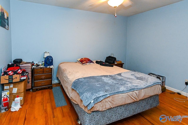 bedroom featuring hardwood / wood-style flooring and ceiling fan