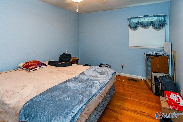 bedroom with ceiling fan and wood-type flooring