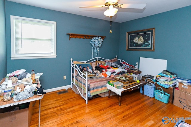 bedroom with hardwood / wood-style flooring and ceiling fan