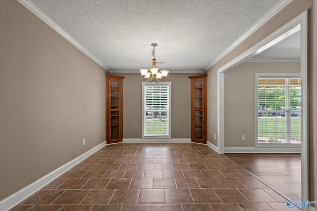 unfurnished dining area featuring a healthy amount of sunlight, crown molding, and an inviting chandelier