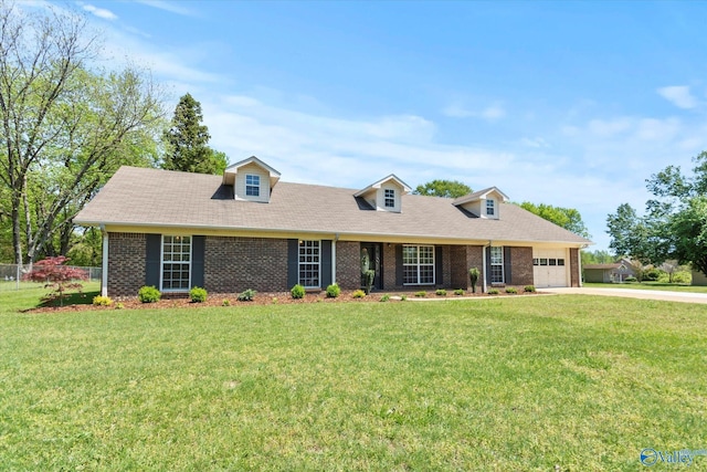 cape cod house with brick siding, a front yard, driveway, and a garage