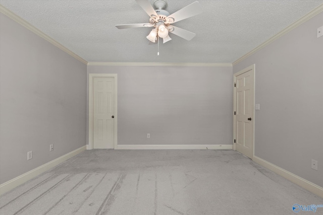 empty room with a textured ceiling, a ceiling fan, and ornamental molding