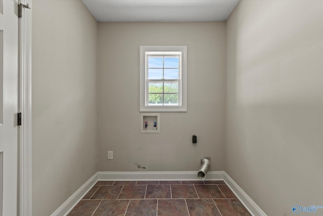 laundry area featuring baseboards, laundry area, and washer hookup