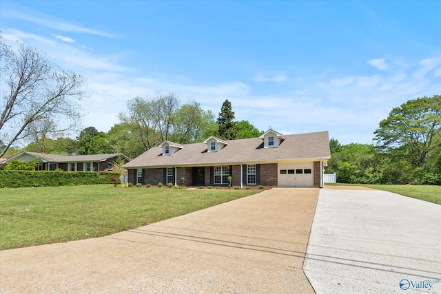 cape cod-style house with brick siding, driveway, a front yard, and a garage