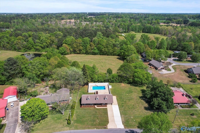 birds eye view of property with a forest view