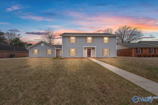 view of front of property featuring central AC and a front lawn