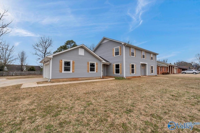 view of front facade featuring a garage, driveway, and a front yard