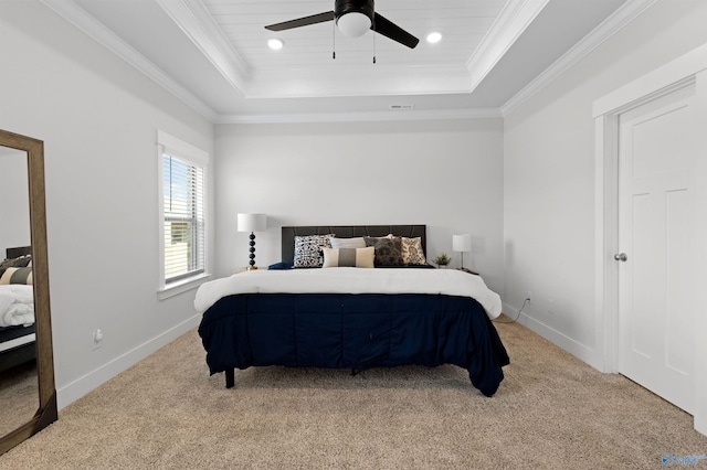 carpeted bedroom with crown molding, ceiling fan, and a tray ceiling