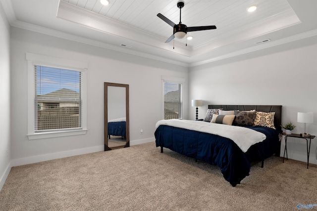 carpeted bedroom with a raised ceiling, crown molding, wooden ceiling, and ceiling fan