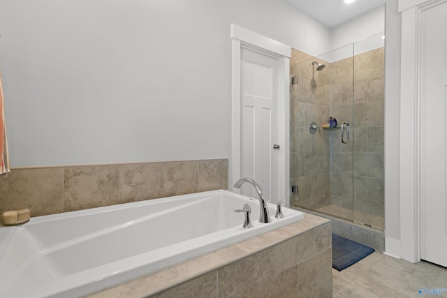 bathroom featuring tile patterned floors and independent shower and bath