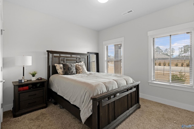 carpeted bedroom featuring multiple windows