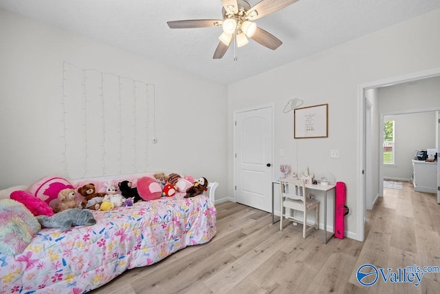 bedroom with light hardwood / wood-style flooring and ceiling fan