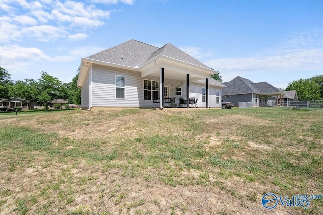 back of property featuring a lawn and a patio