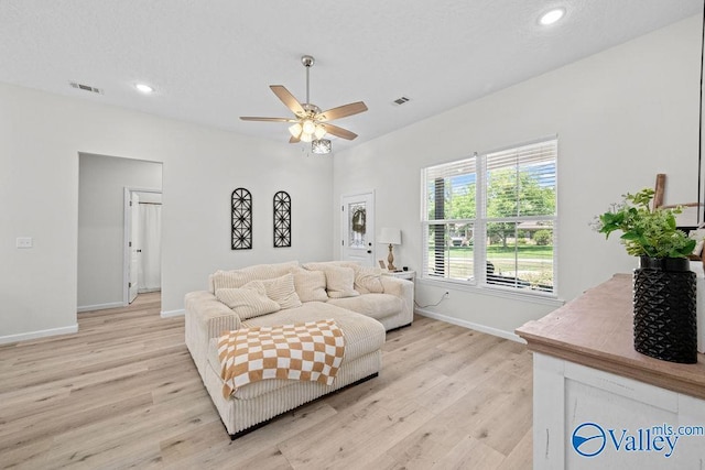 living room with ceiling fan and light wood-type flooring