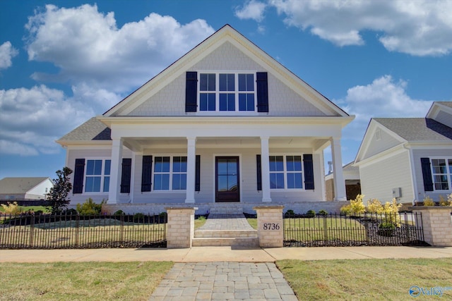 view of front of house featuring covered porch and a front yard