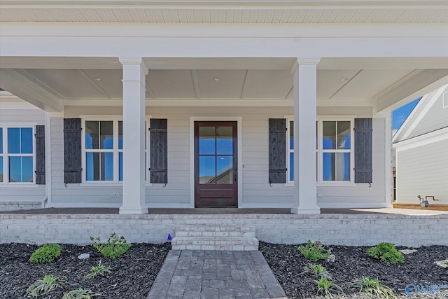 view of exterior entry with covered porch