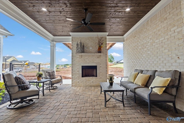 view of patio / terrace featuring an outdoor living space with a fireplace and ceiling fan