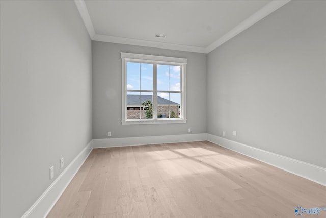 unfurnished room with crown molding and light hardwood / wood-style floors