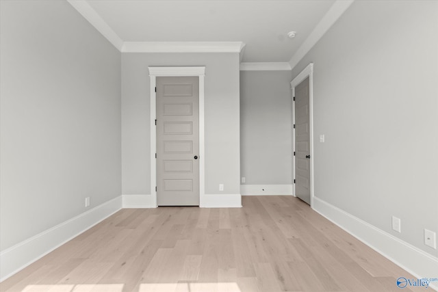 unfurnished bedroom featuring ornamental molding and light hardwood / wood-style floors