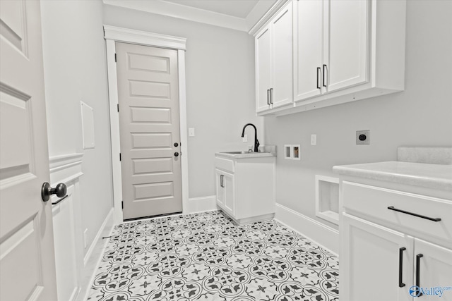 clothes washing area featuring hookup for an electric dryer, ornamental molding, sink, cabinets, and light tile patterned floors