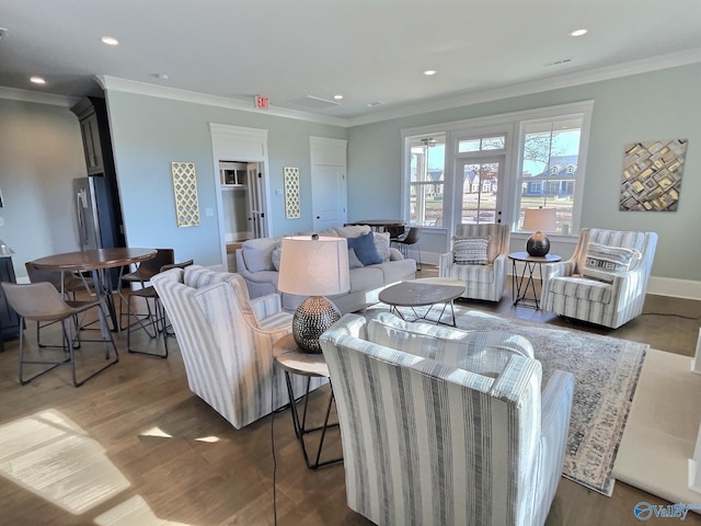 living room featuring hardwood / wood-style flooring and crown molding