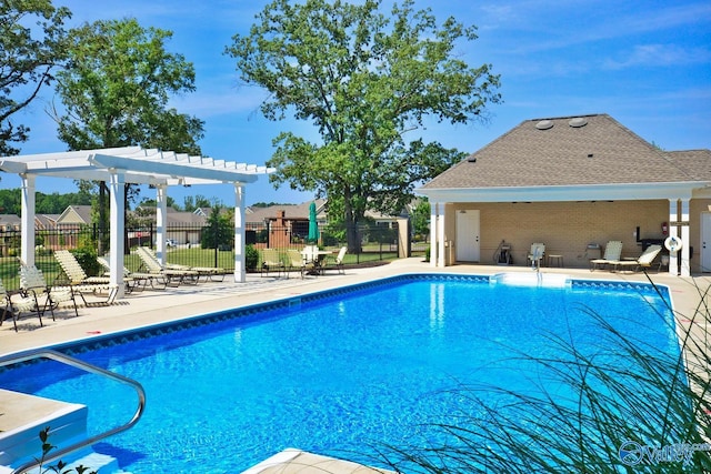 view of swimming pool with a patio and a pergola