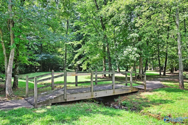 surrounding community with a deck and a lawn