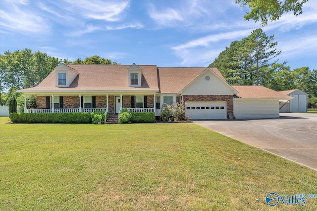 cape cod house featuring a porch and a front yard