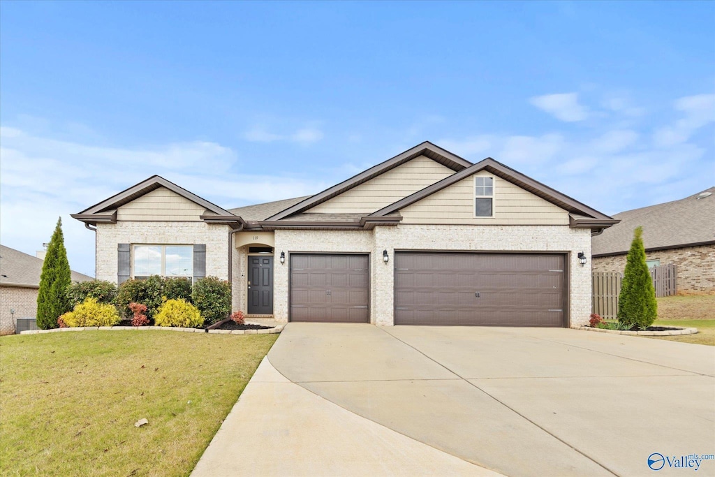 view of front facade featuring a garage and a front lawn